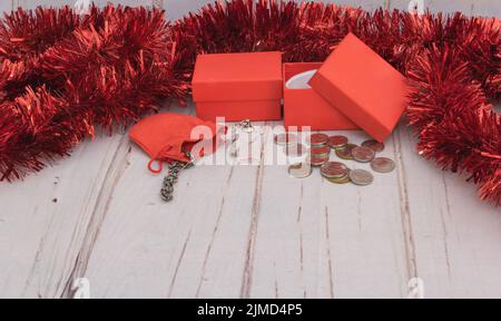 Set of Christmas decorations From above composition of small gift boxes with bright ribbons and small gift boxes placed on wooden table. Stock Photo