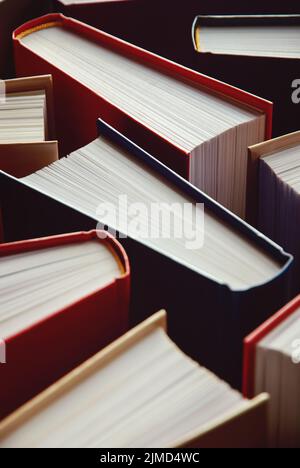 Many hardcover books standing as background, vertical photograph Stock Photo