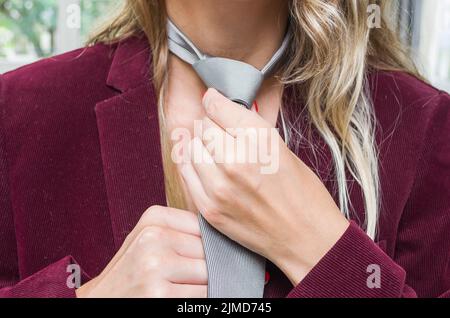 Great concept of women's rights, gender equality, gender, young blond and caucasian woman with tie. Stock Photo