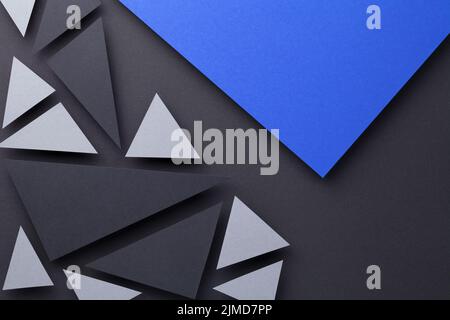 Modern Triangular Shapes Composition Over Black Paper Stock Photo