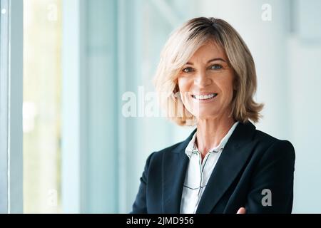 A session with me could get you back on track. Portrait of a confident mature psychologist working in a modern office. Stock Photo