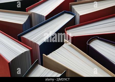 Many hardbound paper books standing, literature background Stock Photo