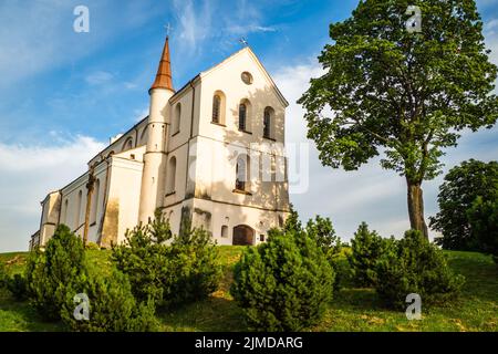 A Small Church in the Middle of the lush Green Spring Landscape on a Sunny Day. Church in Lithuanua Stock Photo