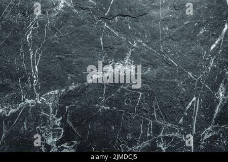 Dark Rough Marble Scratched Abstract Stone Wall Background. Abstract Texture Suitable for Backdrop, Wallpaper, or Decorative Des Stock Photo
