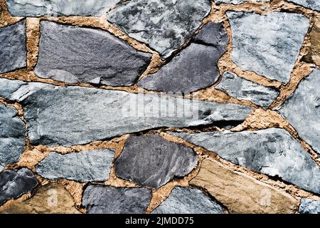 Pattern Gray Color of Modern Style Design Decorative Uneven Cracked Real Stone Wall Surface With Cement Stock Photo