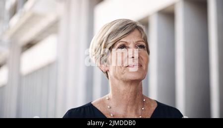 To go big youve got to make big moves. a mature businesswoman walking through the city. Stock Photo