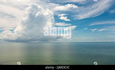 Tropical blue sea and blue sky with clouds. Seascape, aerial view. Flight over the sea. Stock Photo