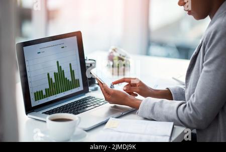 An accountant working on growth, tax review or expenses of a company with graphs or charts on a laptop screen. Closeup of a financial advisor typing Stock Photo