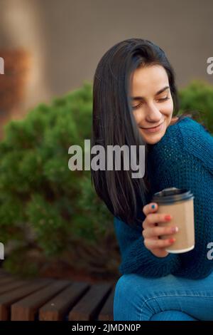 Portrait of adorable dark-haired woman resting in quiet city square Stock Photo