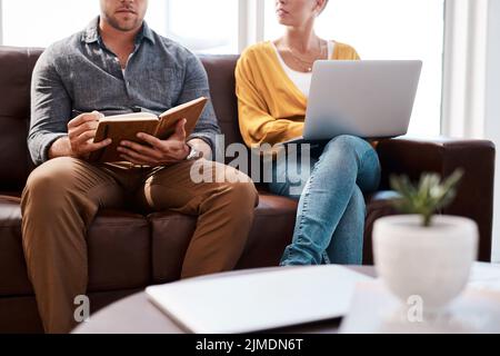 Getting comfy to get creative. Closeup shot of two unrecognisable businesspeople having a discussion while sitting on a couch in an office. Stock Photo