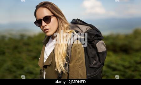 Portrait of adorable beautiful  girl, wearing casual white t-shirt and jacket with a backpack, wandering, exploring the world. S Stock Photo