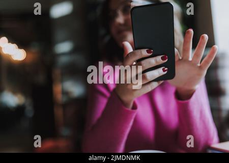 Happy pretty lady is holding mobile phone Stock Photo
