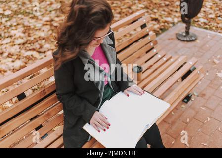 Young beautiful woman studying in the park Stock Photo