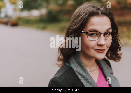Kind smile of attractive young lady in the street Stock Photo