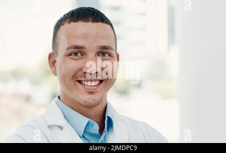 I do it for the good health of the world. Portrait of a confident young scientist working in a modern laboratory. Stock Photo