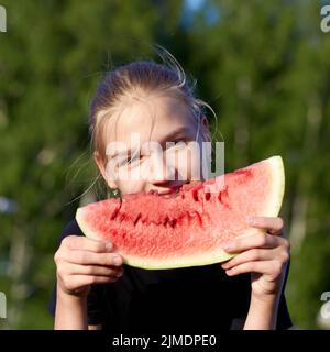Portrait of attractive young girl with watermelon in outdoor Stock Photo