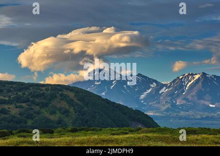 Lenticular cloud formation over volcano Stock Photo