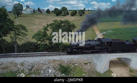 Antique Restored Steam Locomotive Blowing Smoke and Steam Stock Photo