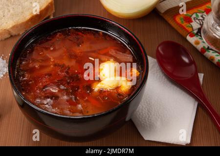 Traditional Ukrainian Russian borscht with sour cream on the bowl. Plate of red beet root soup borsch. Beetroot soup Top view. T Stock Photo