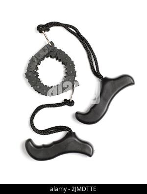 Black portable chain saw with handles on white background. Hand tool for tourism and camping. Stock Photo