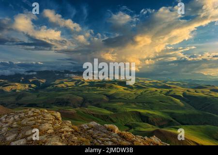 Sunset on hills in Caucasus mountains Stock Photo