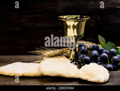 Sour bread, wine, grapes and wheat symbol of Christian communion Stock Photo