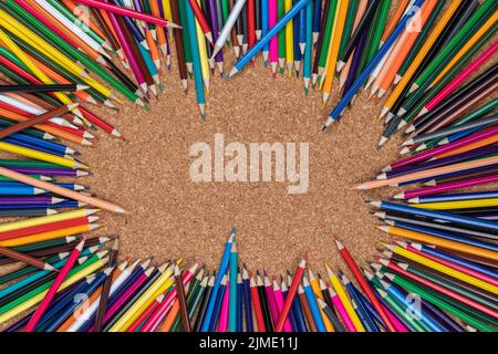 Background photo of colored pencils on a cork plate Stock Photo