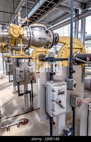 Pipes, tubes, machinery and steam turbine at a power plant Stock Photo