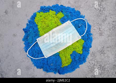 Planet Earth and continents, stabilized painted moss, gray background, medical m Stock Photo