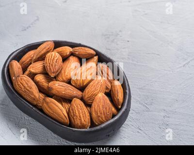 Almond in black plate Stock Photo