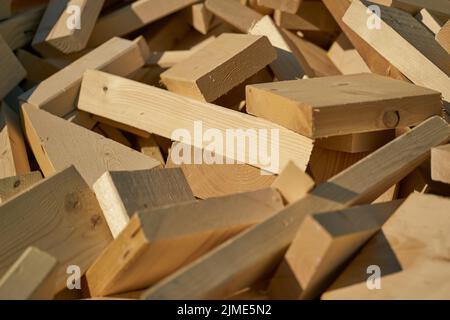 Remains of building material made of wood on the storage yard for processing in a pellet plant Stock Photo