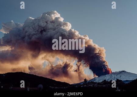 A dramatic view of dense smoke clouds coming out of erupting volcano Stock Photo