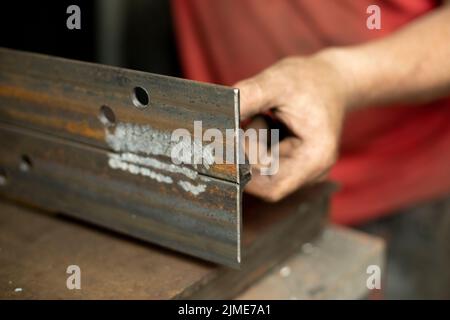 Drilled holes in the metal. Work in a metal workshop. Stock Photo