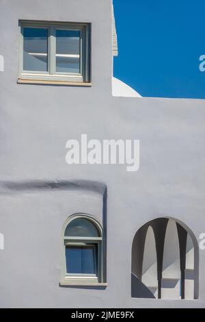 Different Windows on a Gray Wall Stock Photo