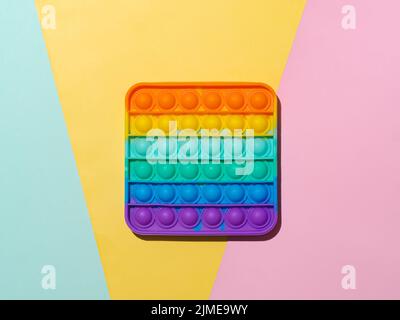 Popit toy on multicolor background, top view Stock Photo