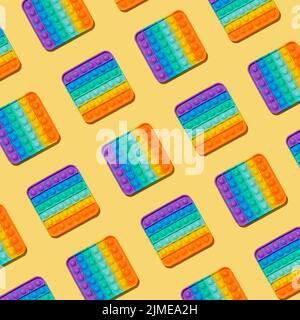 Popit toy pattern on yellow background, top view Stock Photo