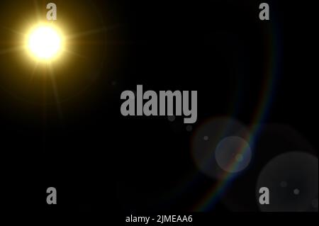 Abstract Natural Sun flare on black. Sun rays light isolated on black background for overlay design. Lens Flare ,Sun Flare. Stock Photo