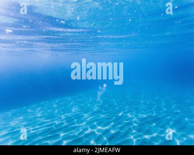 Blue colored clear underwater surface texture with ripples  splashes and bubbles Stock Photo