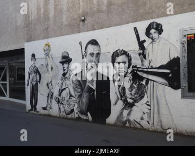 A black and white graffiti on Pali Cinema wall with Marilyn Monroe, Charlie Chaplin, James Bond, Humphrey Bogart in Darmstadt, Germany Stock Photo