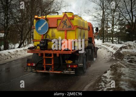 Washing vehicles on road. Special equipment for cleaning on highway. Transport with water. Stock Photo