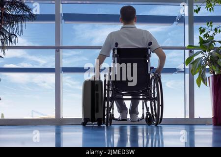 Young man in a wheelchair at the airport Stock Photo