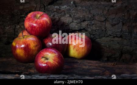 Group of red apples on dark rustic background Stock Photo