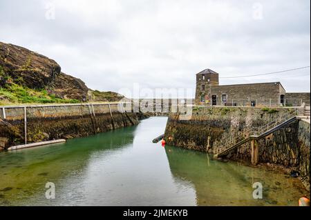 Amlwch, UK- July 8, 2022: The step sided stone walls at Amlch port in North Wales at low tide Stock Photo