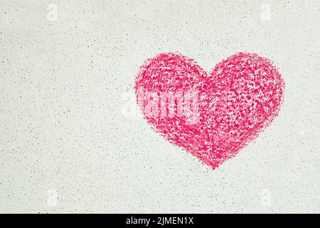 Pink heart drawn with chalk on white wall, copy space Stock Photo