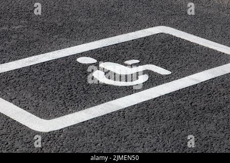 Parking spot for disabled drivers, road marking on asphalt road Stock Photo