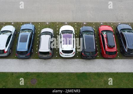 Parking lot with cars in front of a hotel in the city of Kolobrzeg in Poland from bird's eye view Stock Photo