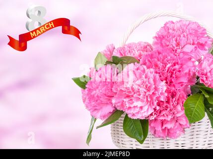 carnations and a ribbon that says congratulations. 8 march - woman's day. Stock Photo