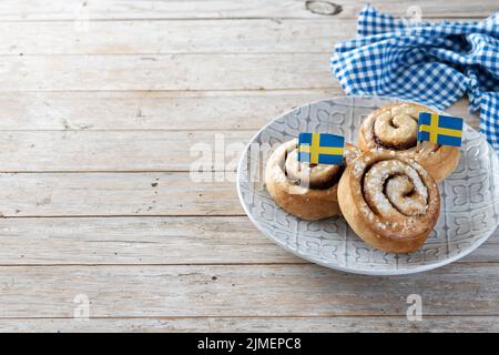 Cinnamon rolls buns. Kanelbulle Swedish dessert on wooden table Stock Photo