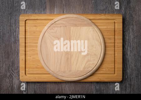 Wooden cutting boards on the kitchen table, multifunctional wooden cutting boards for cutting bread, pizza, or steak serve Stock Photo