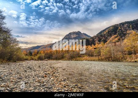 Nature landscape at Kamikochi Japan, autumn fall foliage with pond and mountain Stock Photo